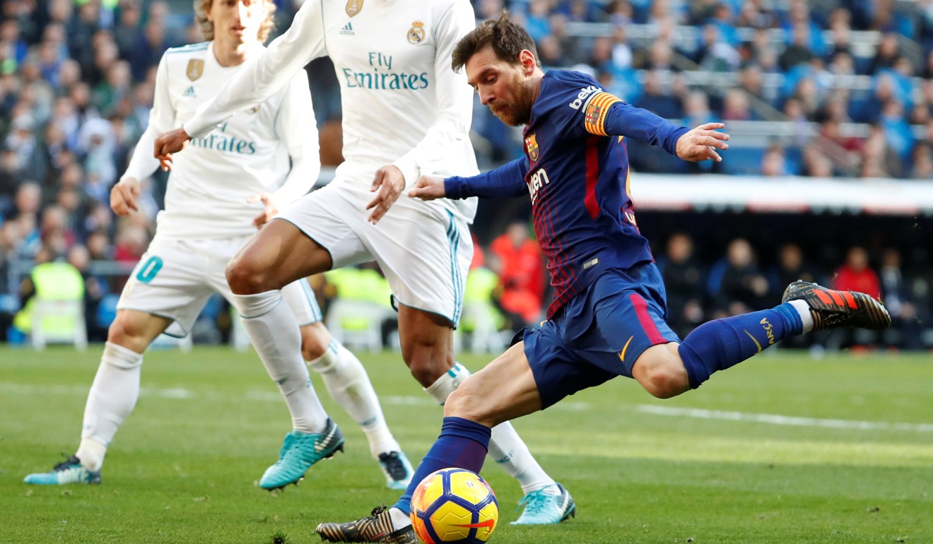 Messi fires a shot against Real Madrid.