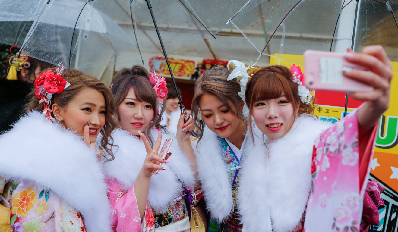 Young Japanese women take selfies during their Coming of Age Day ceremony. Photo: EPA
