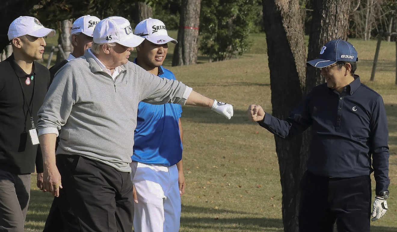 US President Donald Trump and Japanese Prime Minister Shinzo Abe play a round of golf. File photo: AFP