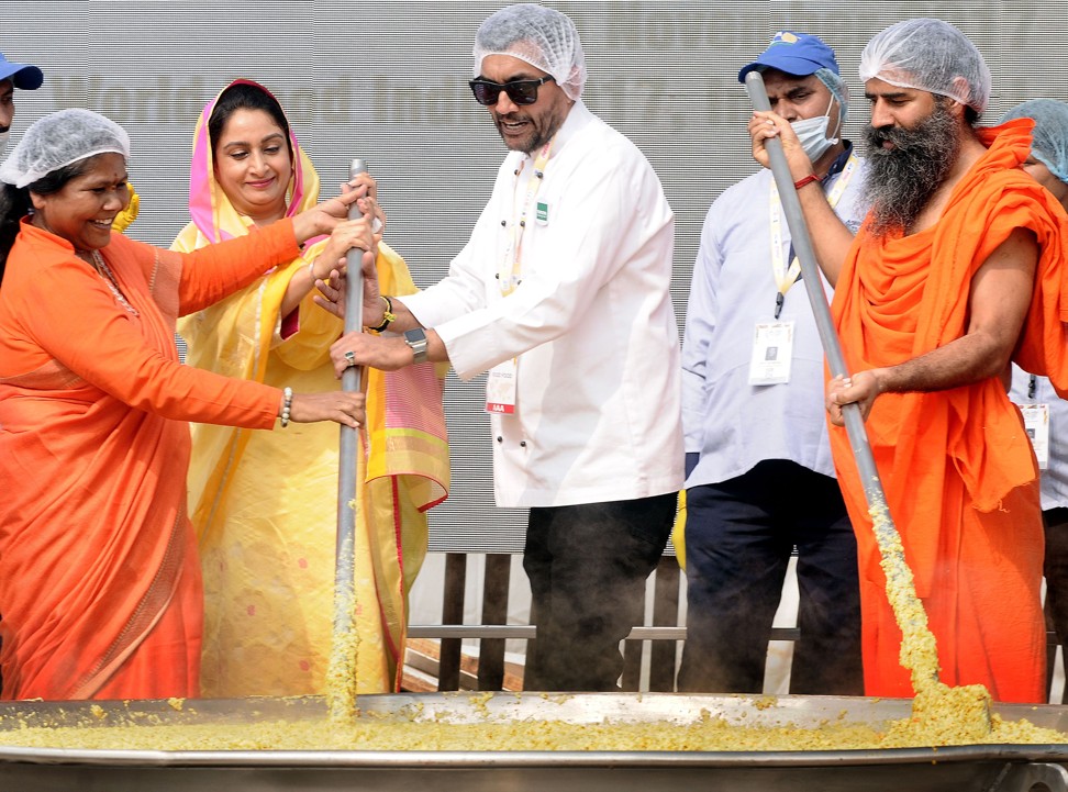 Minister for Food Processing Harsimrat Kaur Badal (in yellow) helps Kapoor and yoga guru Baba Ramdev stir the khichdi at the World Food India exhibition, in New Delhi, in November. Picture: Anadolu Agency