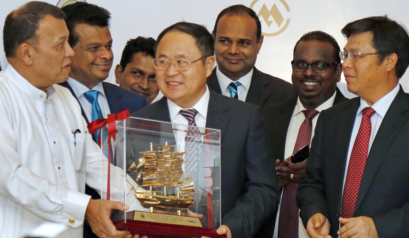 Sri Lankan Ports Minister Mahinda Samarasinghe and Dr Hu Jianhua, executive vice-president of CMG, exchange gifts while China’s ambassador Yi Xianliang looks on during the signing ceremony of the 99-year Hambantota Port Concession. Photo: EPA