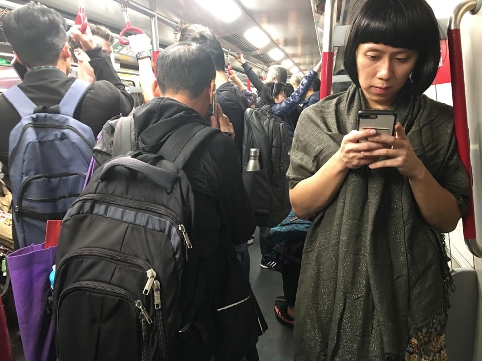Ng travels on the MTR with other passengers. Photo: Kylie Knott