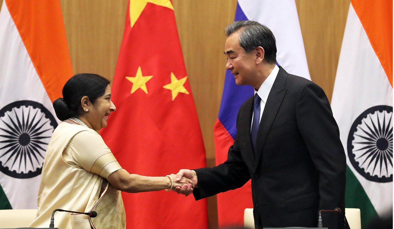 Indian Foreign Minister Sushma Swaraj (left) shakes hands with Chinese counterpart Wang Yi during a joint press briefing in New Delhi last month. Photo: EPA
