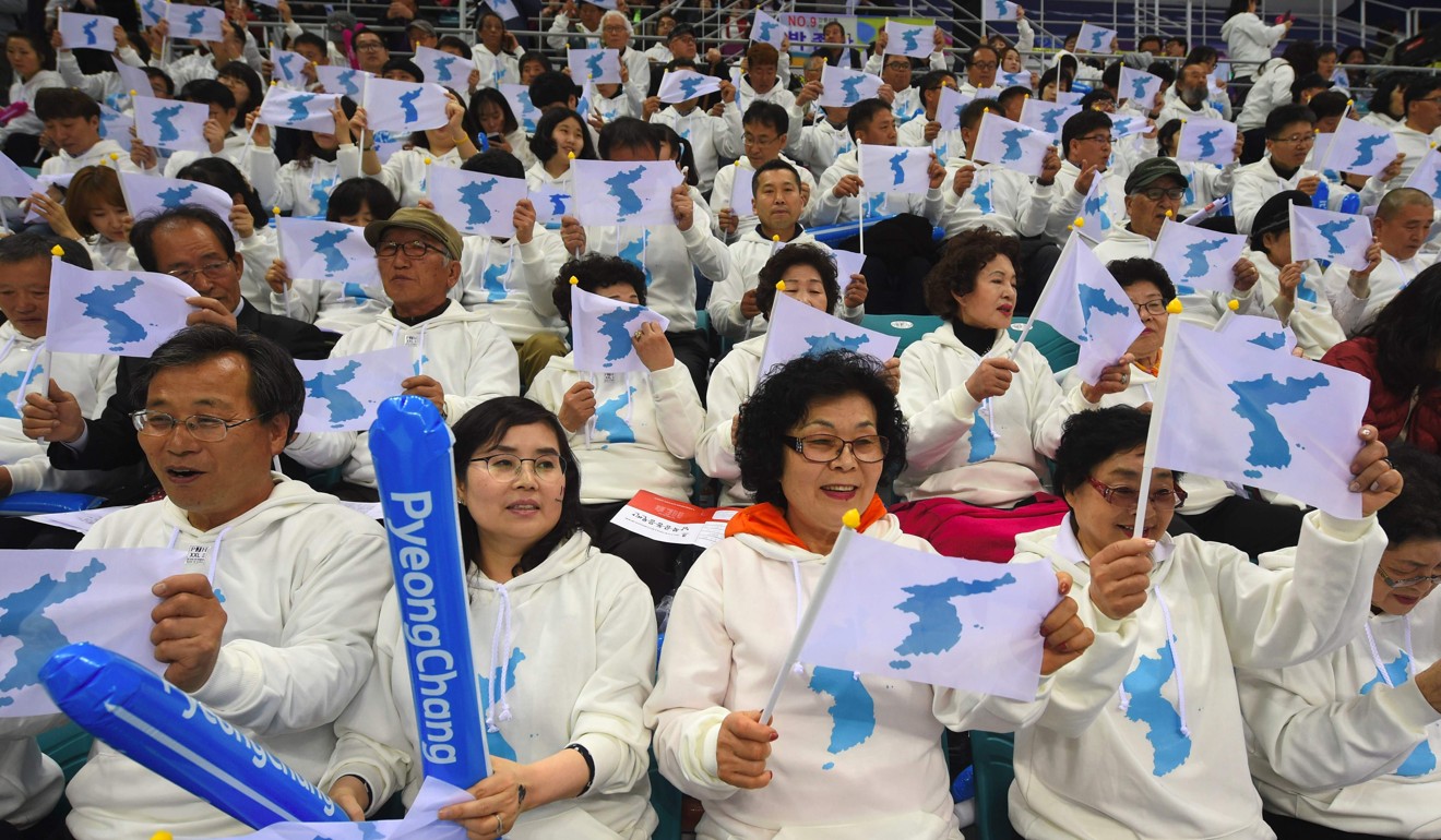 South Korean fans wave “unification flags” as they cheer for North Korean players during the 2017 IIHF Women's World Ice Hockey Championships between South Korea and North Korea in Gangneung. Photo: AFP