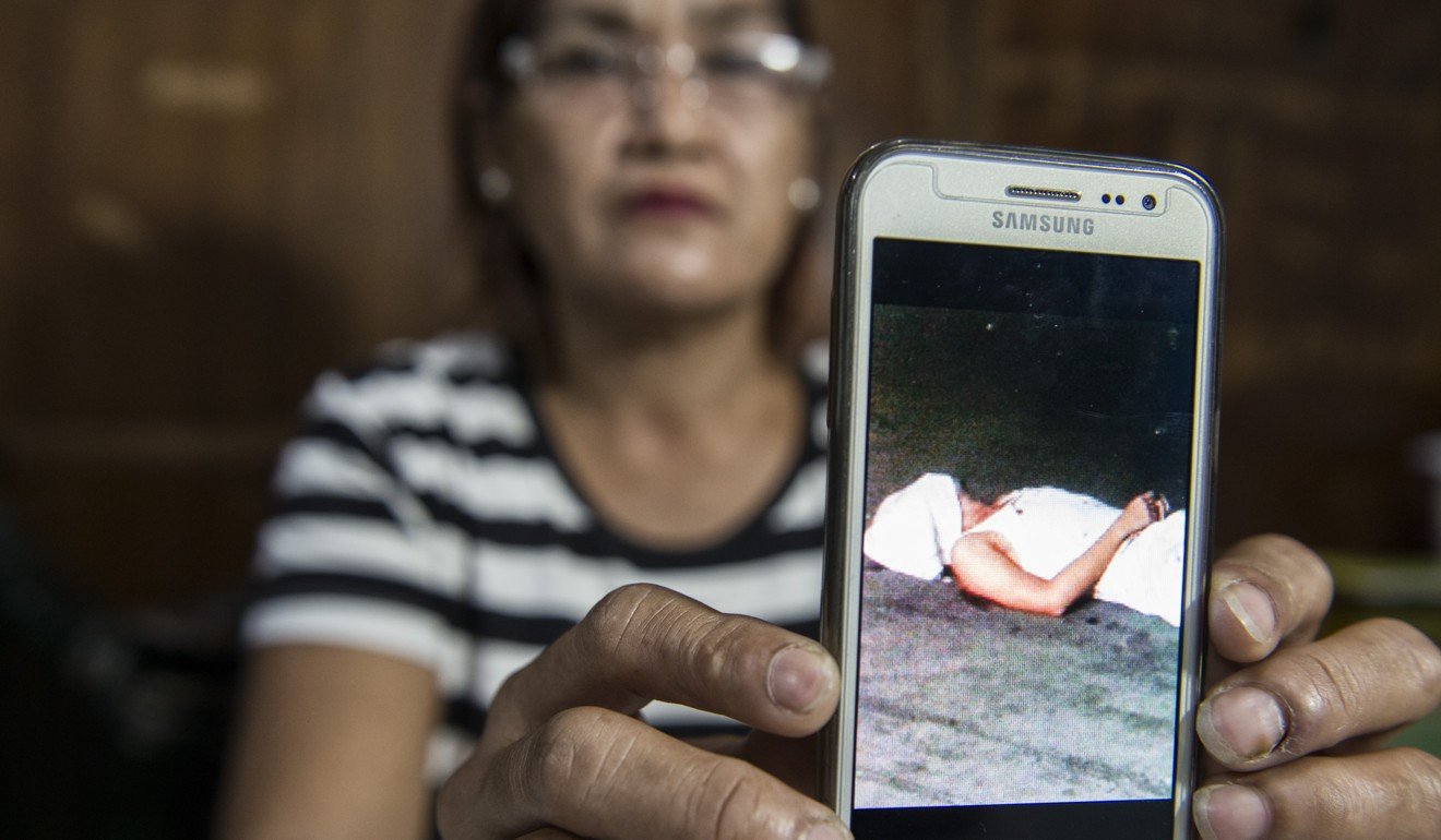Nanette Castillo shows a photo of the body of her son, who, on October 2, 2017, was shot multiple times in the street in what the police describe as a case of mistaken identity.