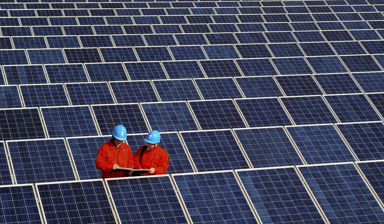 A file picture of workers checking solar panels at a power station in Changxing in China’s eastern Zhejiang province. Photo: Associated Press