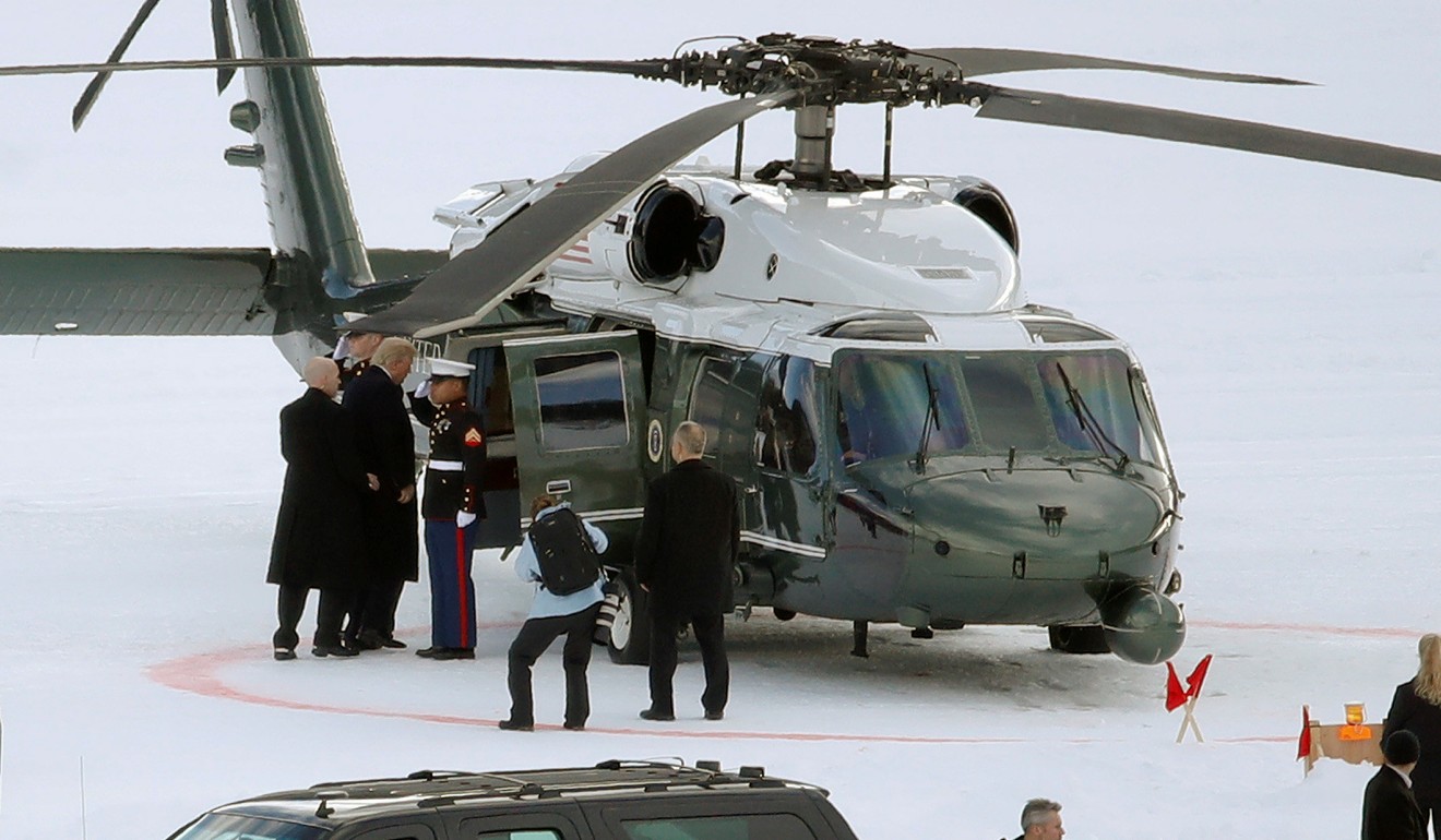 Trump enters a US Air Force helicopter as he leaves Davos. Photo: Reuters