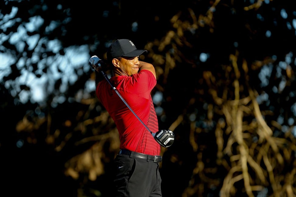 Woods plays his shot from the 13th tee. Photo: AFP