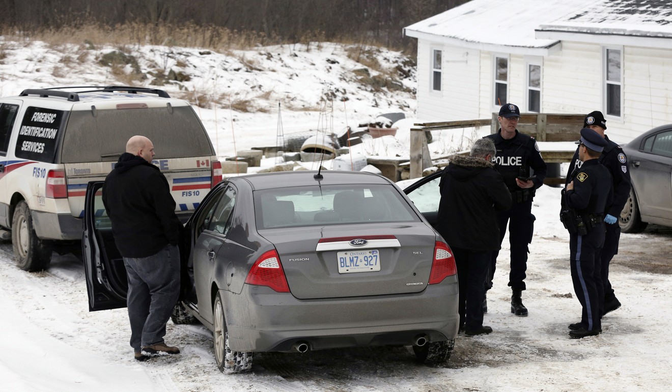 In this January 19, 2018 file photo, forensic officers stand outside a house connected to Bruce McArthur, an alleged serial killer, in Madoc, Ontario. Photo: AP