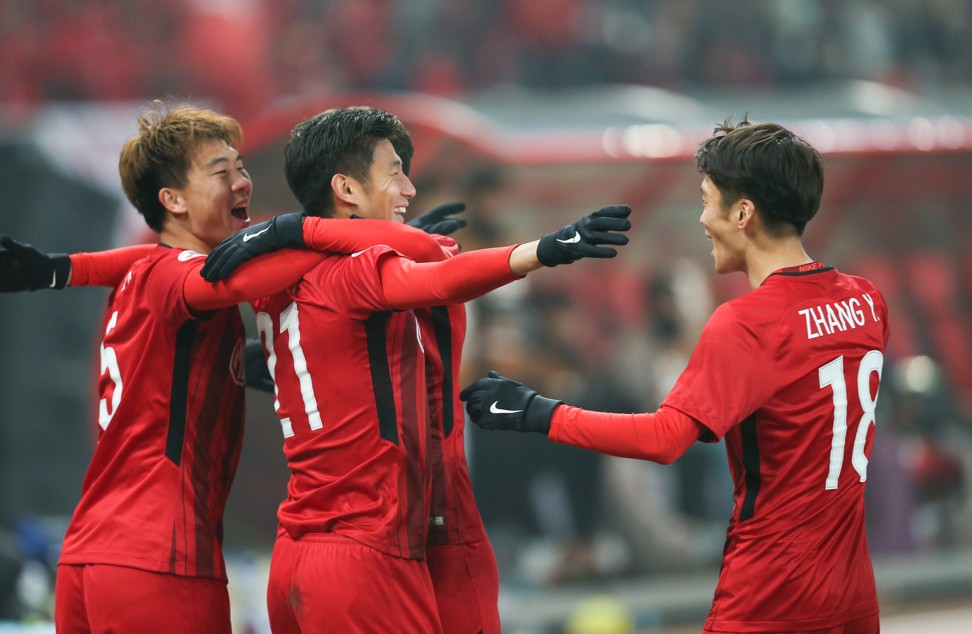 Yu Hai (second left) celebrates his goal. Photo: Xinhua