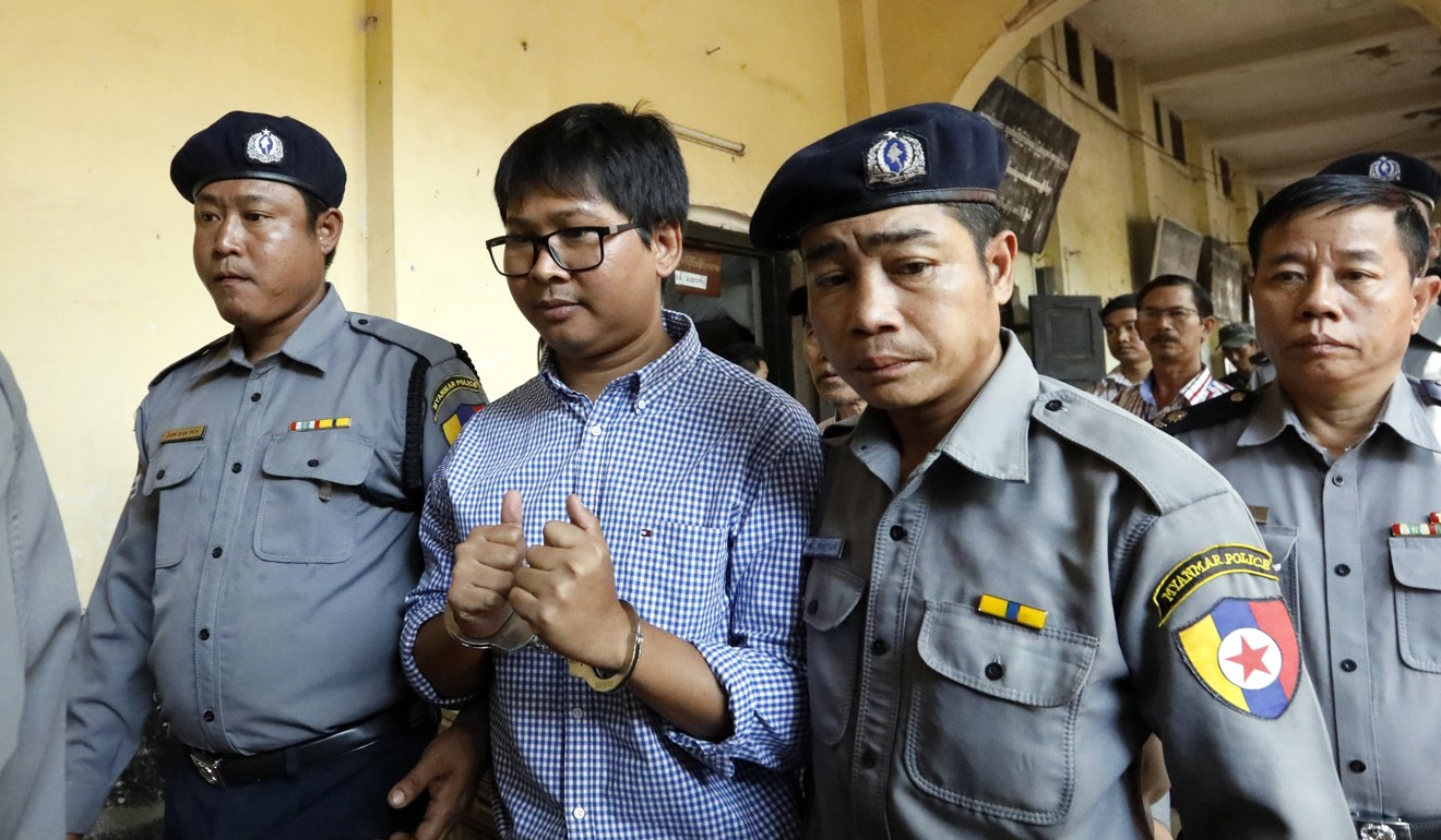 Reuters journalist Wa Lone is escorted by police as he arrives to the court for a hearing in Yangon. Photo: EPA