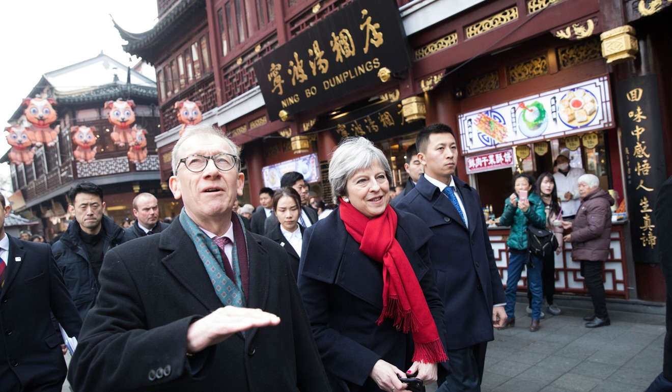 British Prime Minister Theresa May and her husband Philip May visit the Yuyuan Garden retail area in Shanghai on Friday. Photo: EPA-EFE