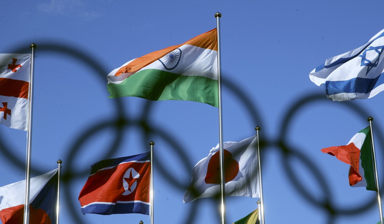 The North Korean flag (left centre) flies among flags from many nations at the Olympic Village in Gangneung, South Korea. Photo: AP