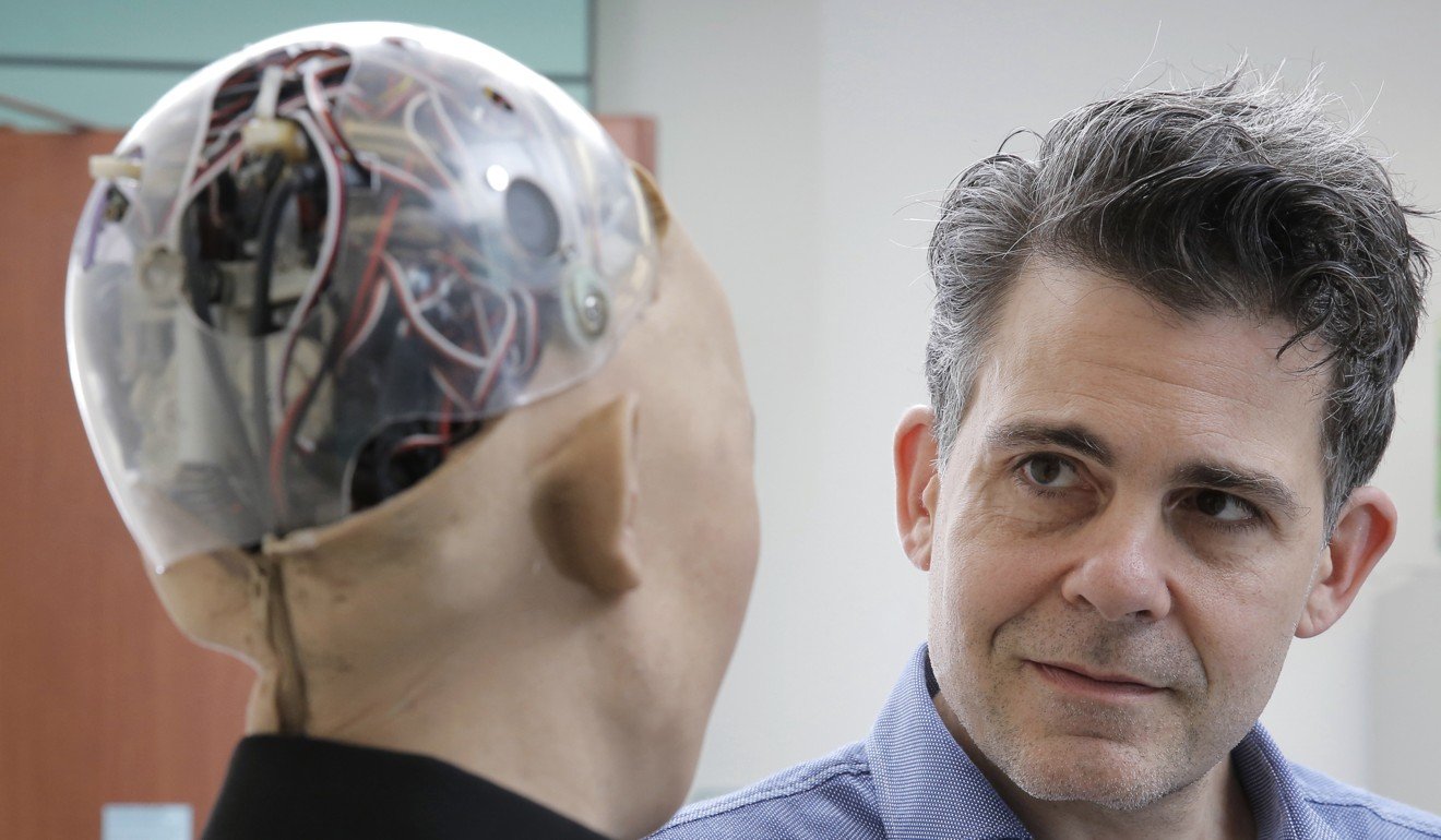 David Hanson, the founder of Hanson Robotics, talks with his company's flagship robot Sophia, a lifelike robot powered by artificial intelligence in Hong Kong. Photo: AP
