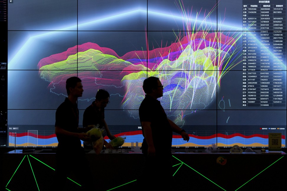 People walk past a live visualisation of internet attacks across China during the 4th China Internet Security Conference in Beijing. Photo: AP