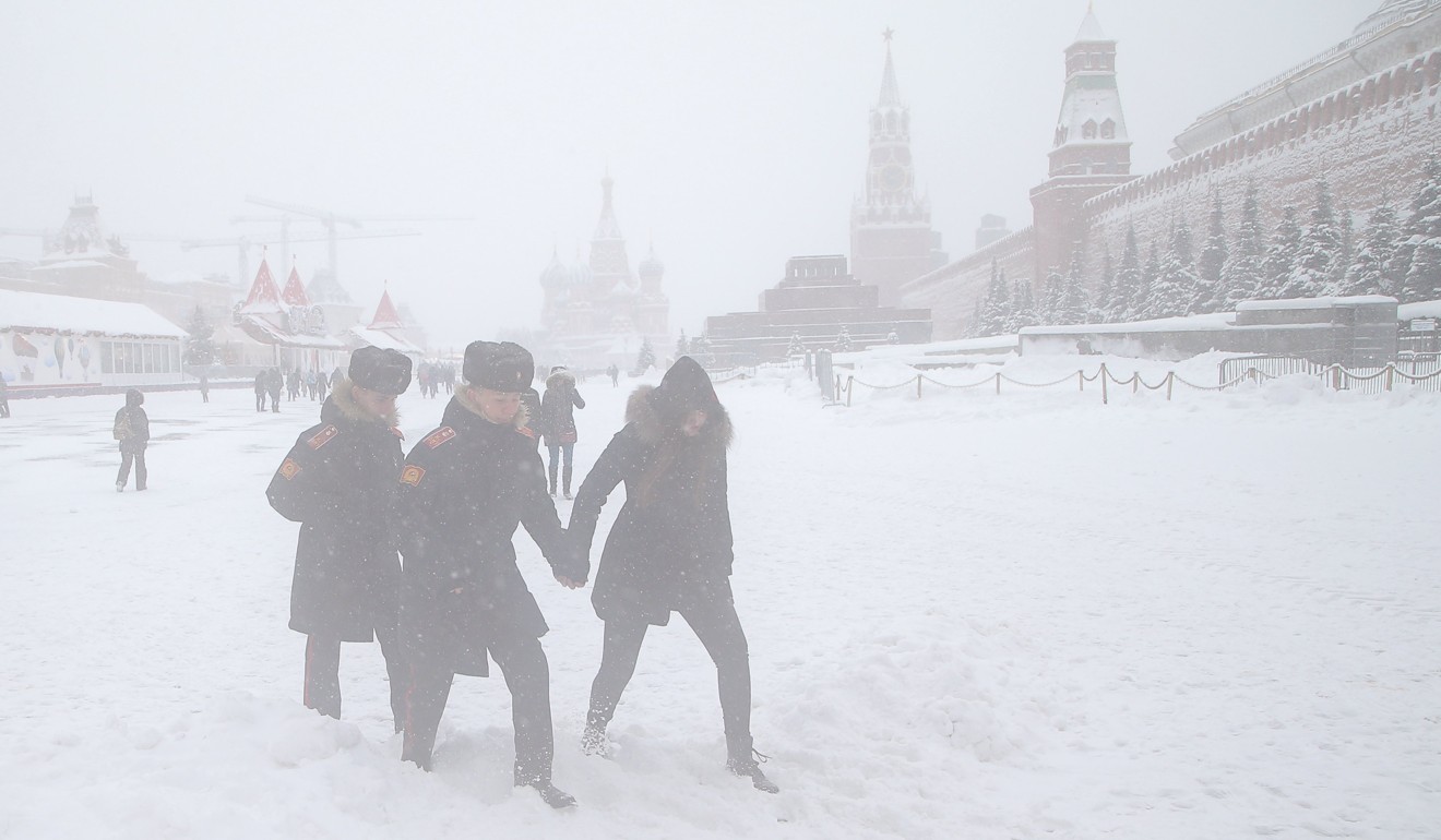 People walk through Red Square in Moscow on Sunday. Photo: EPA