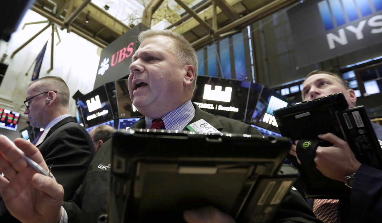 Trader George Ettinger, centre, works on the floor of the New York Stock Exchange on February. 6, 2018. The Dow Jones industrial average fell as much as 500 points in early trading, bringing the index down 10 per cent from the record high it reached on January 26. Photo: AP