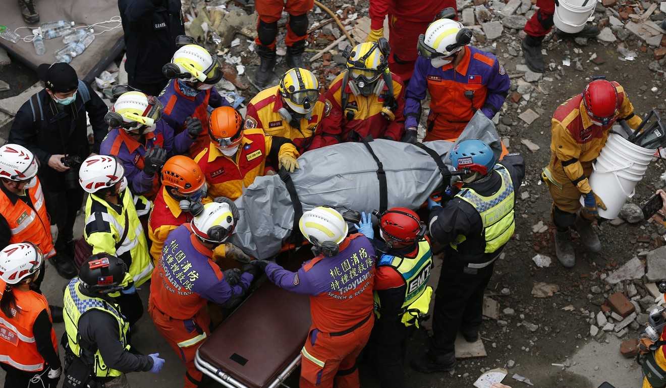 Rescuers removing one of the bodies of the Hong Kong couple from the rubble of their hotel on Friday. Photo: EPA-EFE