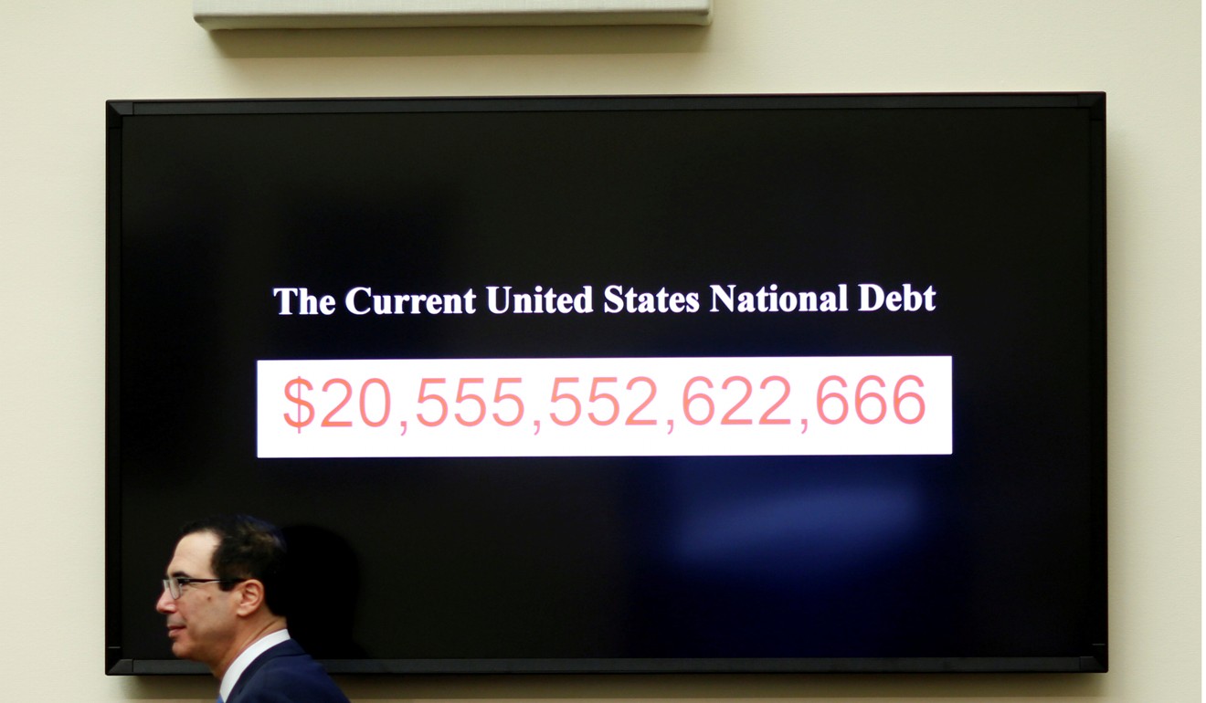 Treasury Secretary Steven Mnuchin walks past a display of the US national debt. Photo: Reuters