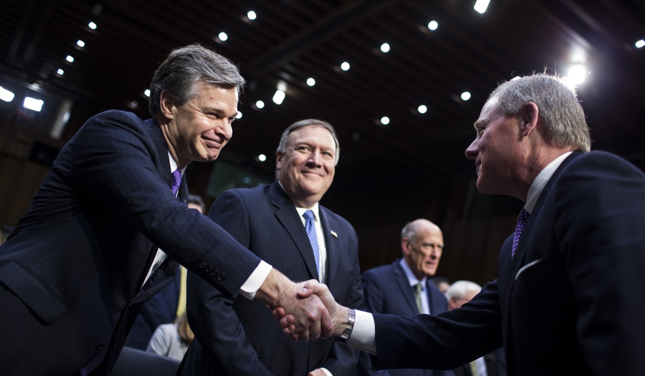 Christopher Wray, director of the Federal Bureau of Investigation, left, shakes hands with chairman Senator Richard Burr, a Republican from North Carolina, before testifying during a Senate Intelligence Committee hearing on worldwide threats in Washington. Photo: Bloomberg