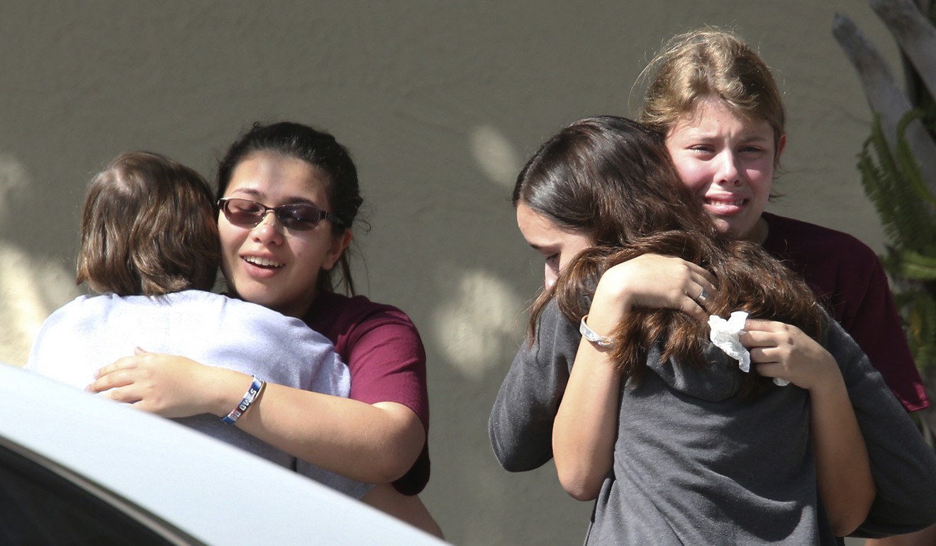 Students grieve outside Pines Trail Centre where counsellors are present after Wednesday's mass shooting at Marjory Stoneman Douglas High School in Parkland, Florida, on February 15, 2018. Photo: AP 