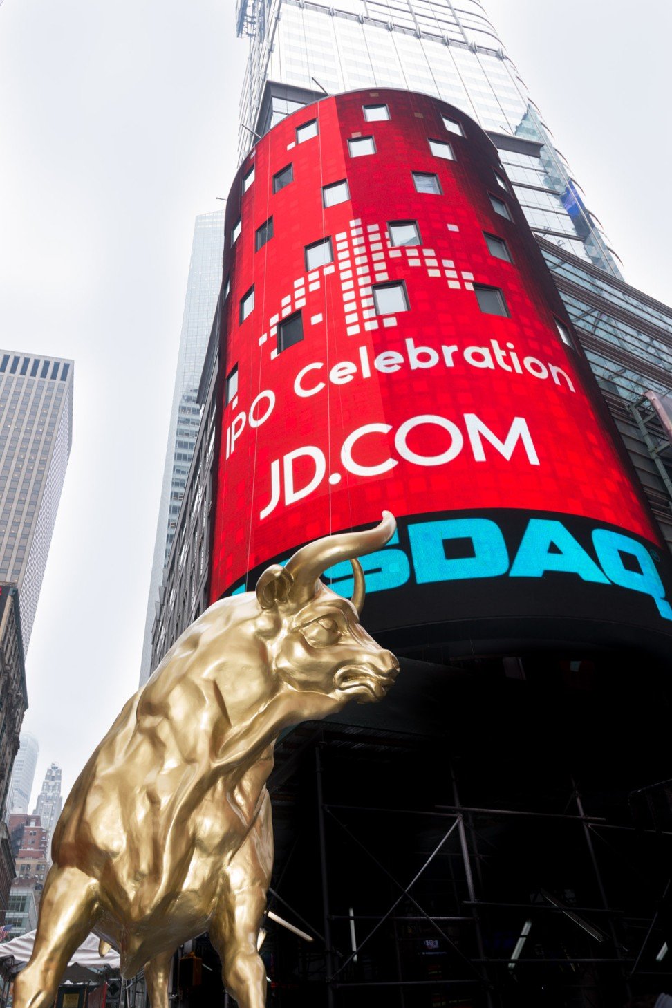 Video screens show logos for JD.com and Nasdaq above an aggressive bull figure in Times Square, New York, in 2014. File photo: Nasdaq OMX
