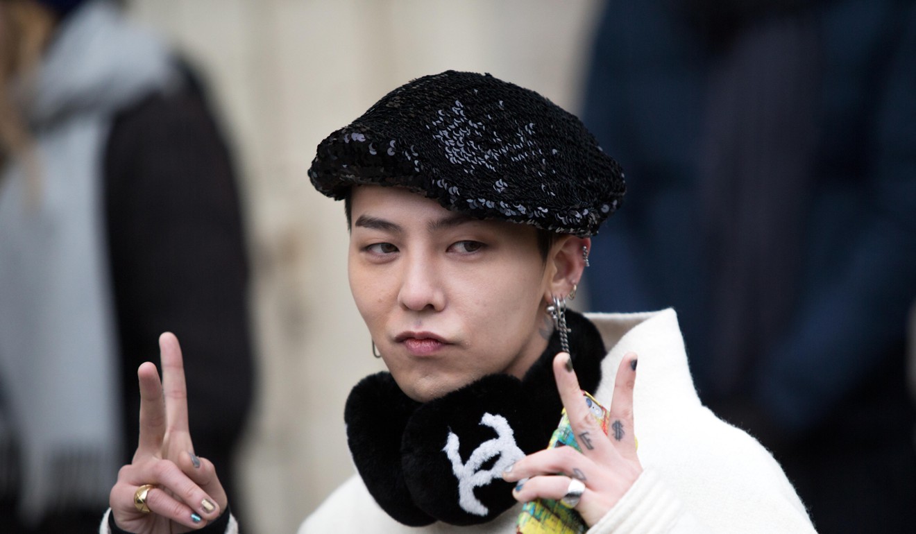 Taeyang’s bandmate G-Dragon arrives at a Chanel fashion show in Paris. Photo: Alamy