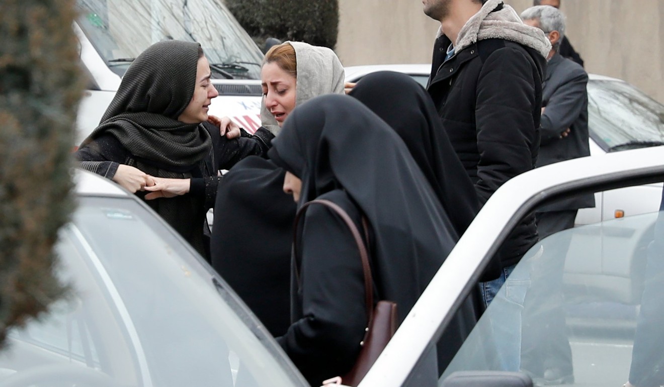 Relatives of passengers of the Aseman Airline flight near a mosque at Tehran’s airport. Photo: EPA