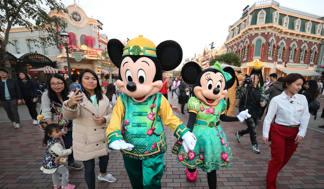 Mickey Mouse and Minnie Mouse dress in festive Lunar New Year clothes in January. Photo: Winson Wong