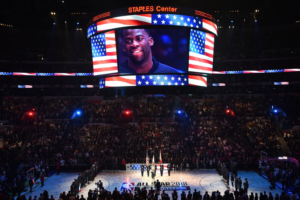 NBA All-Star Draymond Green (on screen) cracks a smile as Fergie performs. Photo: AFP