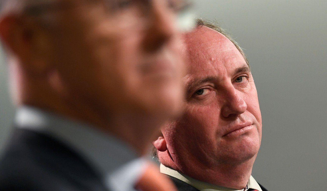 Australian Deputy Prime Minister Barnaby Joyce sits with Prime Minister Malcolm Turnbull. Joyce has announced he will resign from his post amid sexual harassment allegations and an ongoing affair scanda. Photo: AFP