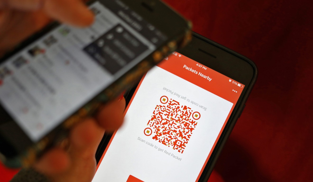 A WeChat user scanning a QR code to retrieve a digital red envelope on the WeChat app on a mobile phone during the Lunar New Year period. Photo: EPA