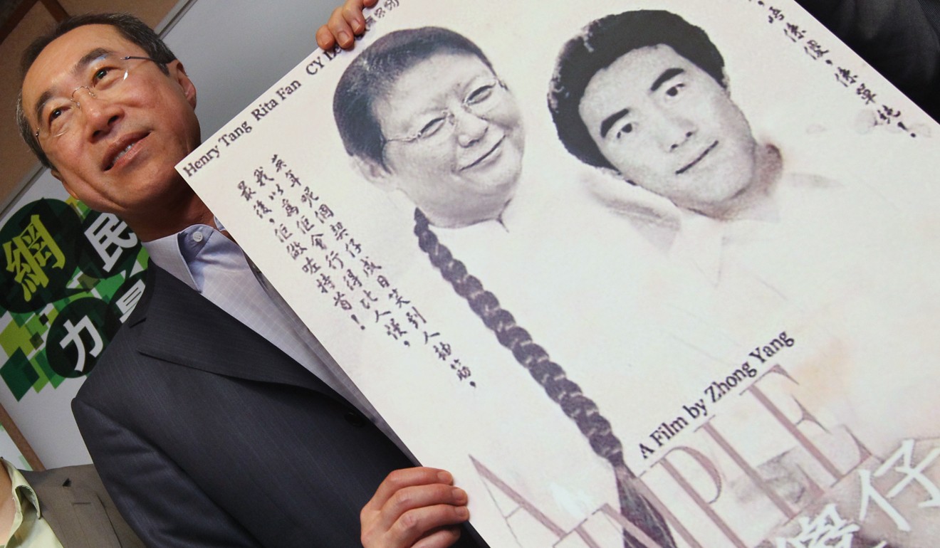 Henry Tang with a mock movie poster of him and Rita Fan ahead of the 2012 election. Photo: SCMP 