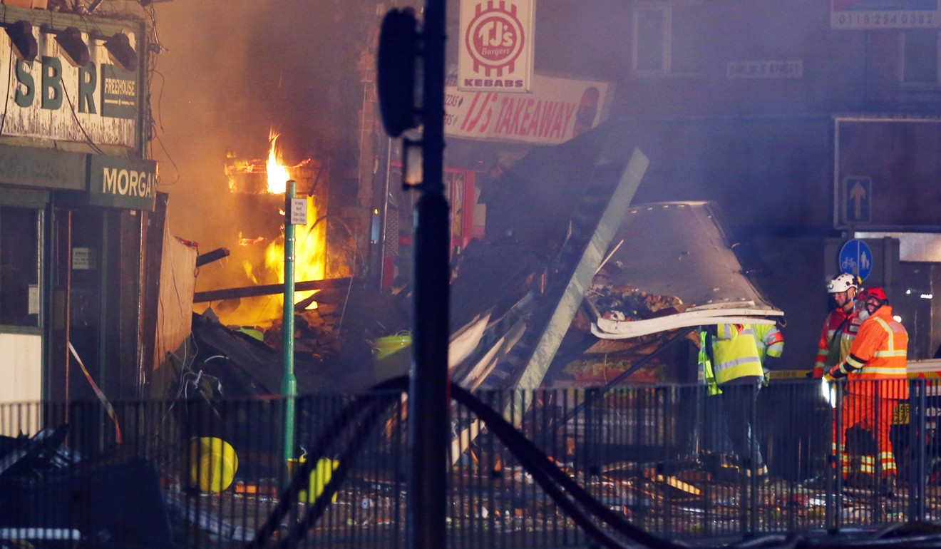 Members of the emergency services at the scene of the explosion. Photo: EPA