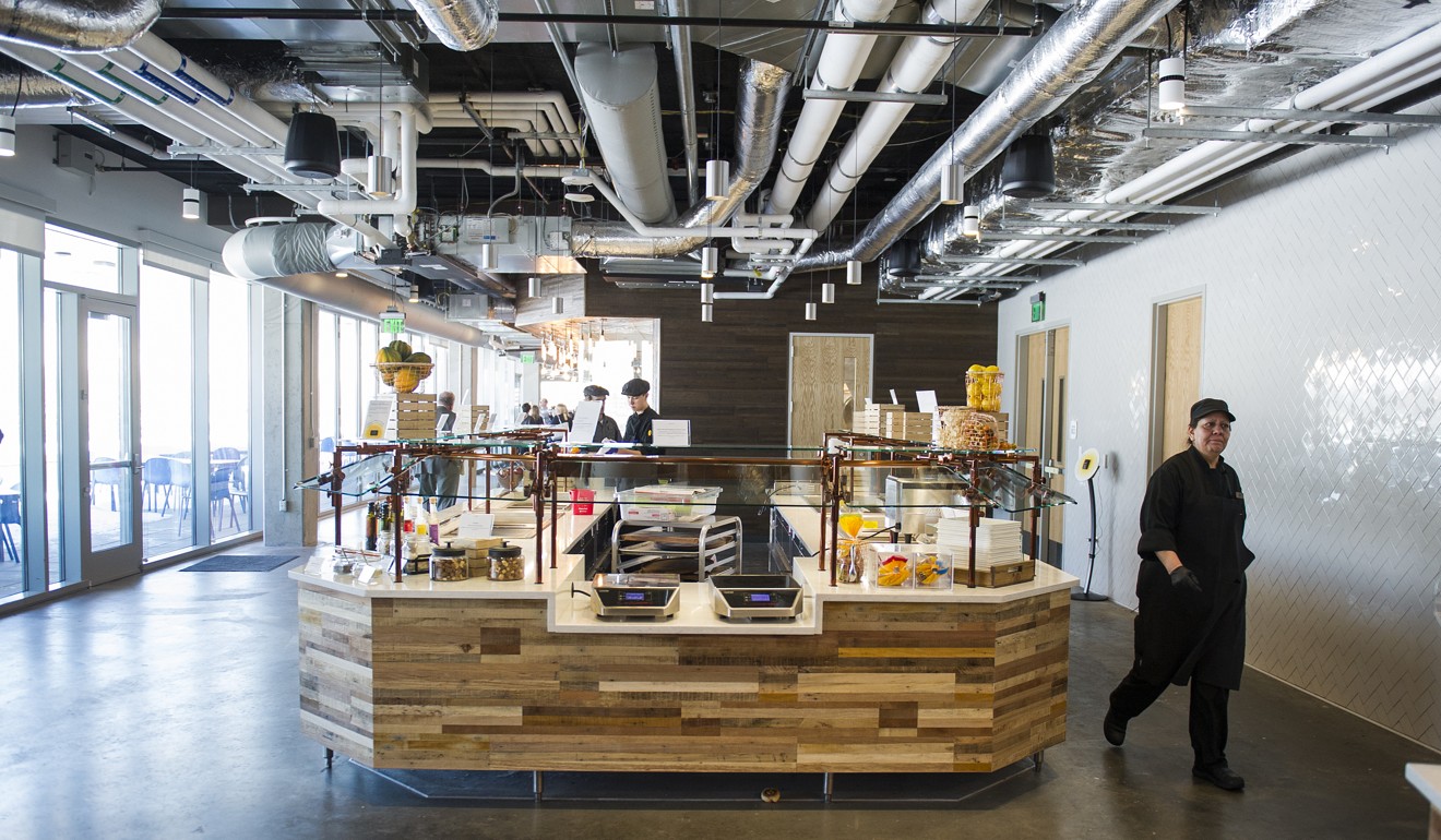 Employees walk through the new Google campus’ cafeteria. Photo: Bloomberg