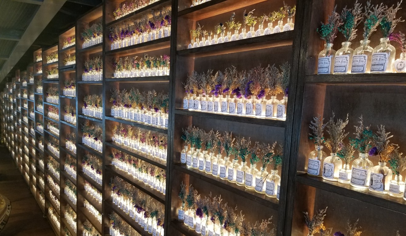 A wall of dried flowers in tiny bottles in Dear Lilly