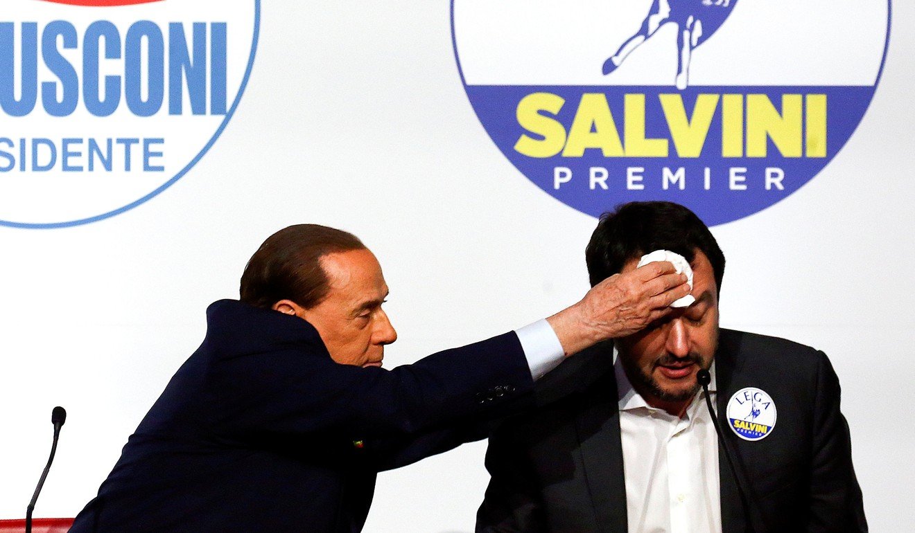 Berlusconi wipes the sweat off Matteo Salvini during the meeting in Rome. Photo: Reuters