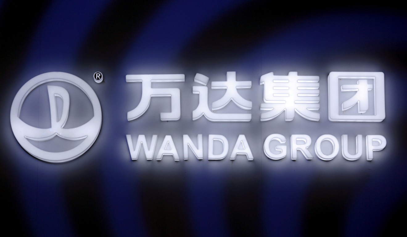 A sign of Dalian Wanda Group in China glows during an event in Beijing. Photo: Reuters