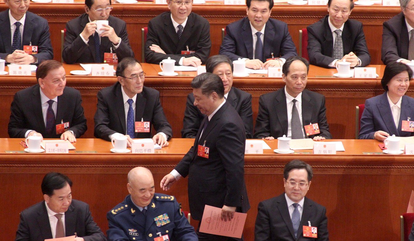 President Xi Jinping carries his ballot paper past NPC deputies before voting on the constitutional revisions on Sunday. Photo: Simon Song
