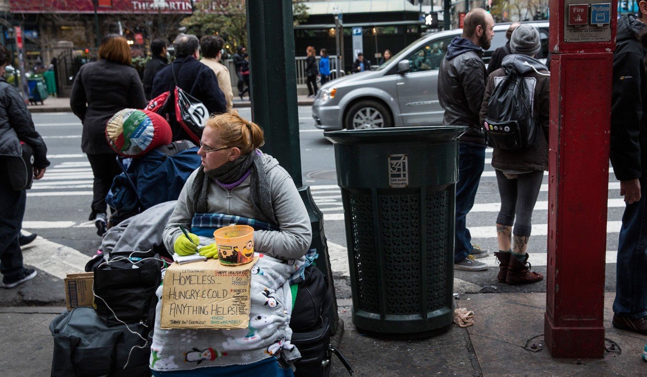 A woman begs for change in New York City. The United States came in at 18th on the UN Sustainable Development Solutions Network’s 2018 World Happiness Report, down from 14th place last year. While income per capita in the US increased, the happiness index has been hit by weakened social support networks. Photo: AFP