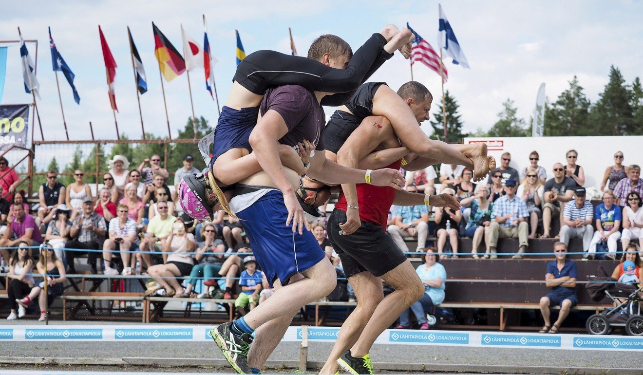 Couples compete in the Wife Carrying World Championships in Finland. The Nordic country has been ranked the happiest in the world by the UN. Photo: Reuters