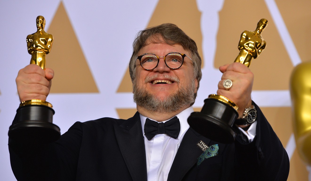 Mexican filmmaker Guillermo del Toro holds aloft the best picture and best director Oscars for his film The Shape of Water. Some critics point to recent winning films’ niche appeal as a reason for declining audiences for the Academy Awards. Photo: Scott Varley/TNS
