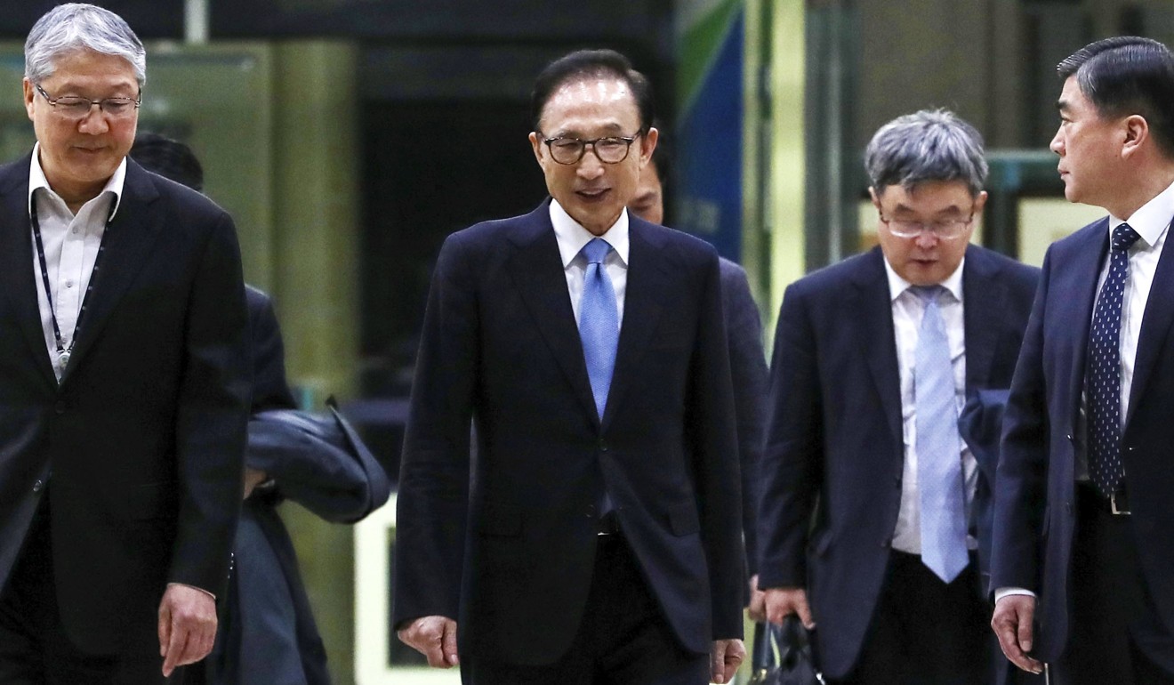 Former South Korean President Lee Myung-bak (centre) leaves the Seoul Central District Prosecutors' Office in Seoul on Thursday. Photo: EPA