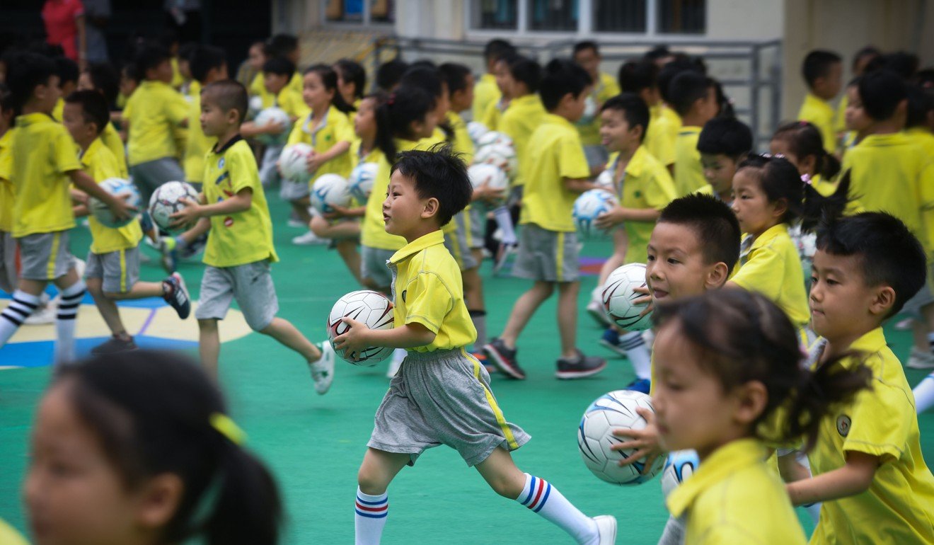 Children play with footballs during a football festival in Changxing County. They will be part of the first generation of Chinese youngsters to grow up playing the game. Photo: Xinhua