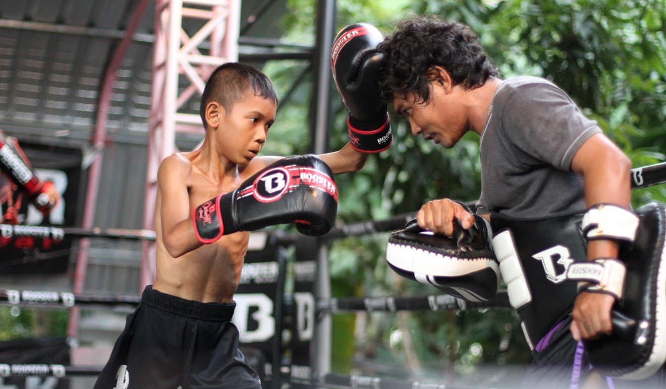 A boy learns Muay Thai moves at the Wor. Watthana gym. Photo: Wor. Watthana