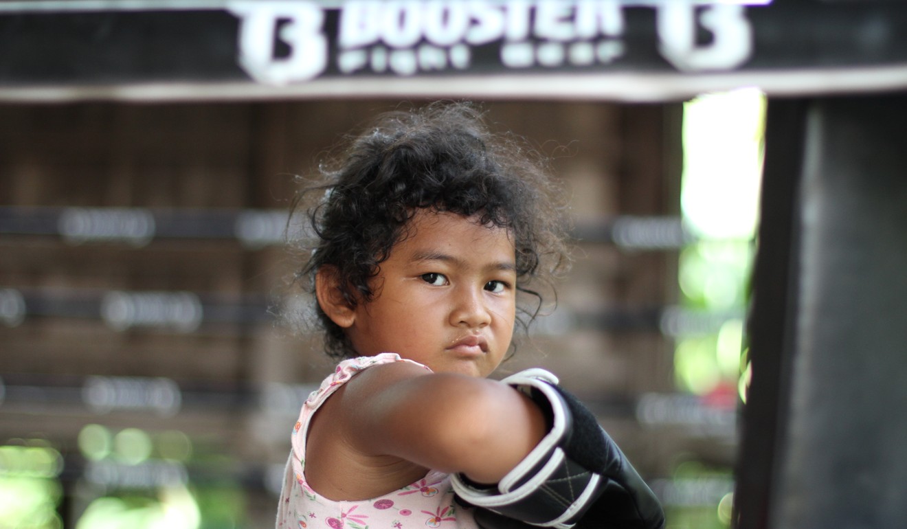 A village child visits Wor. Watthana Muay Thai Gym in northeastern Thailand. Photo: WOR. WATTHANA