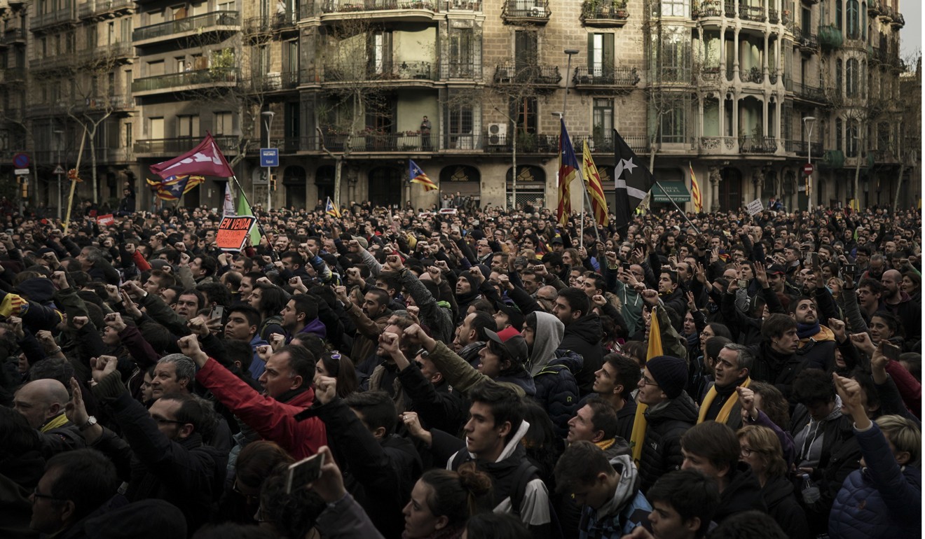 Catalonian independence supporters gather near the Spanish government office in Barcelona, Spain, on Sunday. Photo: AP