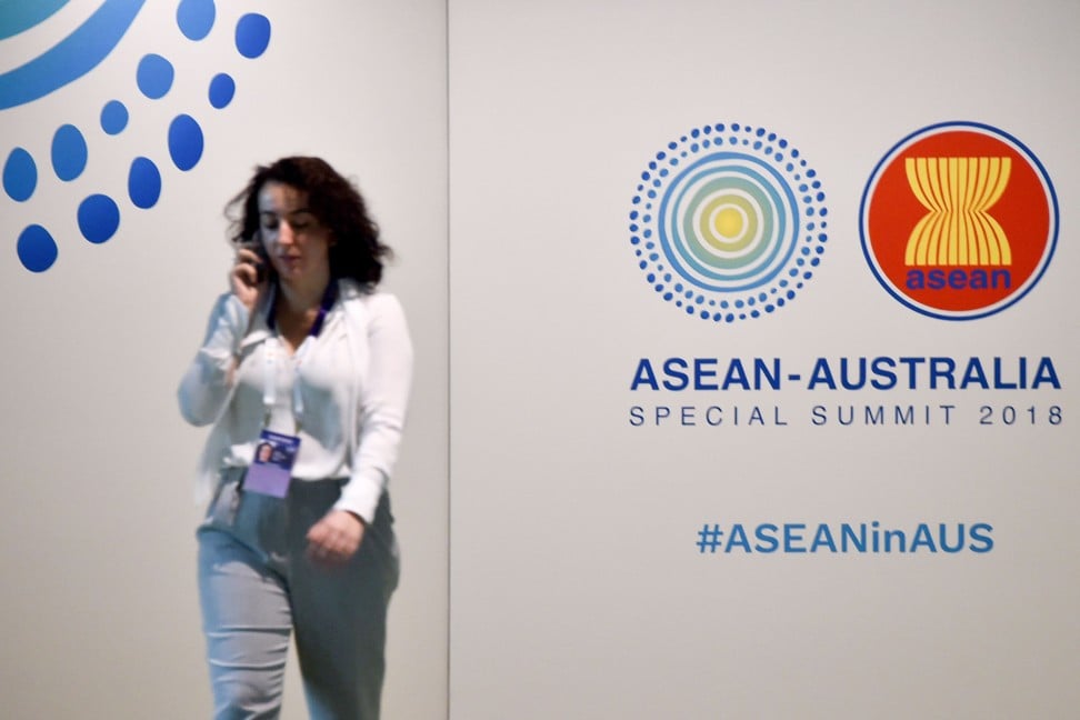 A woman walks in front of a sign for the Association of Southeast Asian Nations summit in Sydney earlier this month. Photo: AFP