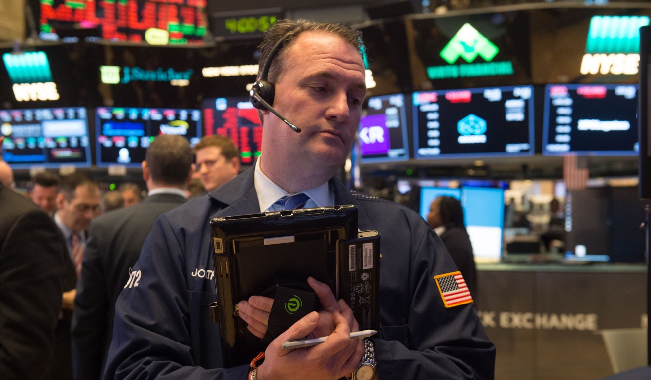 Traders work on the floor at the New York Stock Exchange on March 19, 2018. Shares of big technology companies such as Facebook have taken a hit following reports of a privacy scandal. Photo: AFP