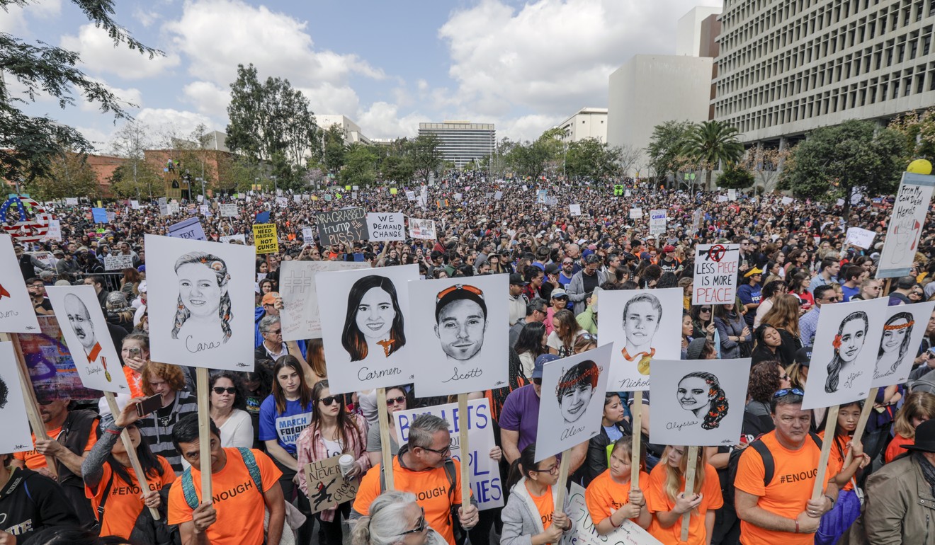 Marchers carry the portraits of 17 who lost their lives in the Parkland High School shooting, drawn by Gracie Pekrul, 16, student of Simi Valley Oak Park Independent School, at the March For Our Lives rally in Los Angeles on March 24, 2018. Photo: Los Angeles Times/TNS